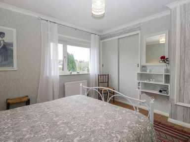 A bedroom with a bed and a chair at Apple Byrd in Kendal