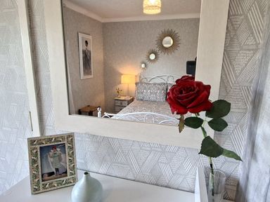 A bedroom with a mirror and a bed at Apple Byrd in Kendal
