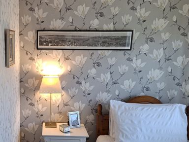 A bedroom with a bed and nightstand at Apple Byrd in Kendal