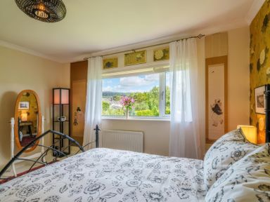 A bedroom with a bed and a window at Apple Byrd in Kendal