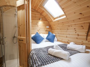 A bedroom with a bed, shower and towels at Oak View in Rhayader