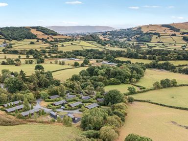 An aerial view of fields and cottages at Oak View in Rhayader