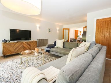 A living room with a sofa and television at Harbour Heights in Weymouth