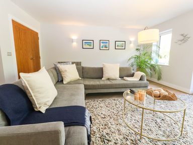 A living room with a sofa and coffee table at Harbour Heights in Weymouth