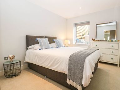 A bedroom with a bed and bedside table at Harbour Heights in Weymouth