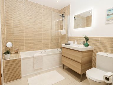 A bathroom with a bathtub and sink at Harbour Heights in Weymouth
