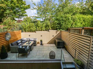 An outdoor garden with seating area and planters at Harbour Heights in Weymouth