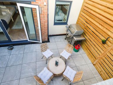 An outdoor space with seating and barbecue grill at Harbour Heights in Weymouth