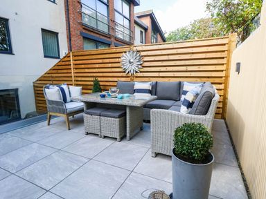 An outdoor patio with seating and a table at Harbour Heights in Weymouth