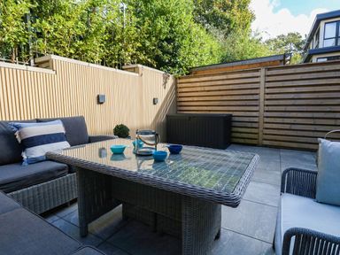 A patio area with seating and a table at Harbour Heights in Weymouth
