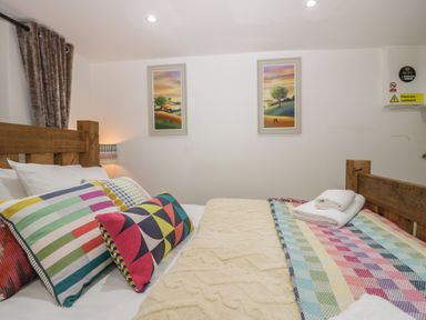 A bedroom with bed and colorful pillows at Park View Studio in Ambleside