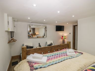A bedroom with a bed and a television at Park View Studio in Ambleside