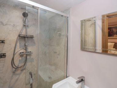 A bathroom with a shower and sink at Park View, Ambleside