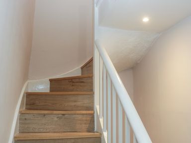 A staircase with wooden steps and white handrail at Park View in Ambleside