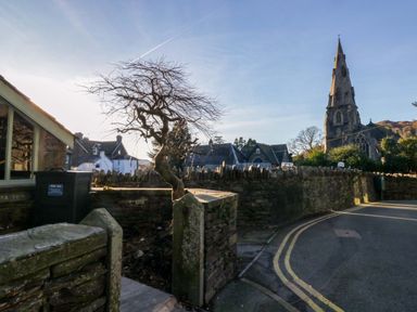A street view featuring a church and a tree at Park View in Ambleside