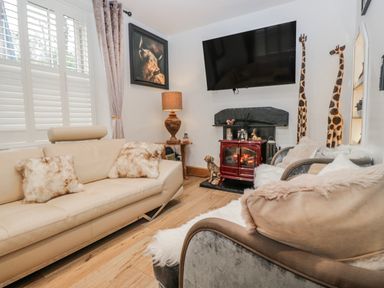 A living room with a fireplace and a sofa at Park View in Ambleside
