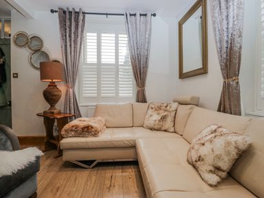 A living room with a sofa and lamp at Park View in Ambleside