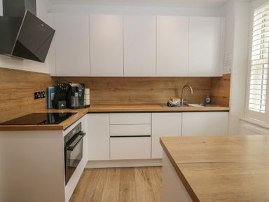 A kitchen with cabinets, a sink, and appliances at Park View in Ambleside