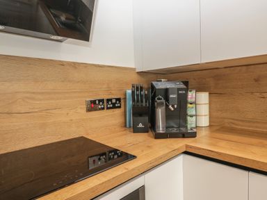 A kitchen with a coffee machine and knife block at Park View in Ambleside