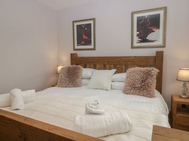 A bedroom with a bed and artwork at Park View in Ambleside