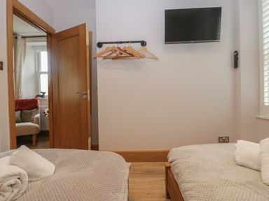 A bedroom with two beds and a television at Park View in Ambleside