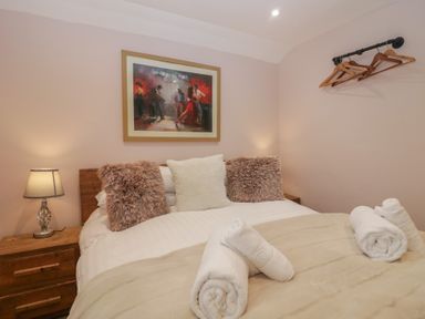A bedroom with a bed, pillows, and wall art at Park View in Ambleside