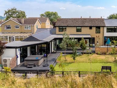 An outdoor area with a hot tub and deck at Manor Farm House in Merton near Bicester