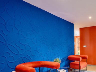 A living room with a blue wall and orange wall at Manor Farm House in Merton near Bicester