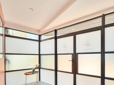 An entryway with glass panels and a table with a vase at Manor Farm House in Merton near Bicester