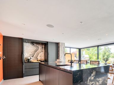 A kitchen with a central island and modern fixtures at Manor Farm House in Merton near Bicester