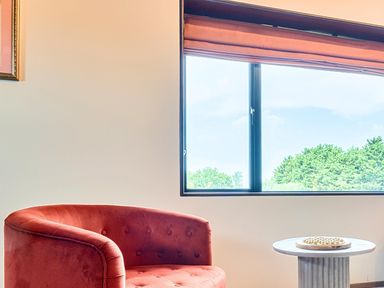 A living room with a chair and table at Manor Farm House in Merton near Bicester