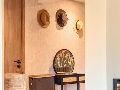An entryway with hats on the wall and a console table at Manor Farm House in Merton near Bicester