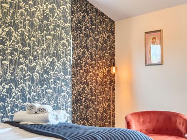 A bedroom with a bed and towels at Manor Farm House in Merton near Bicester