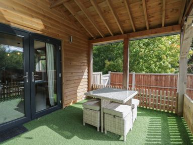 An outdoor seating area with a table and chairs at Willow Cottage in Whiteparish