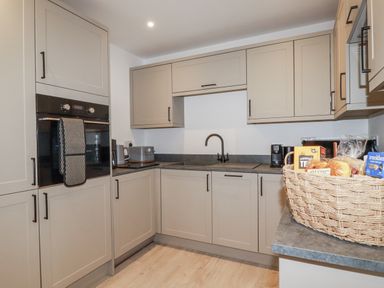 A kitchen with kitchen cabinets and appliances at Barn 2