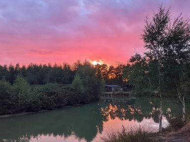 A scenic view of water and trees at Lakewood Retreat in Woodhall Spa