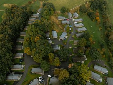 An aerial view of cabins and trees at Askrigg in Aysgarth