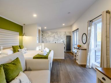 A bedroom with two beds and a kitchenette area at Somersby (Pet) in Louth