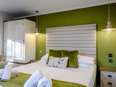 A bedroom with a bed and wardrobe at Somersby (Pet) in Louth