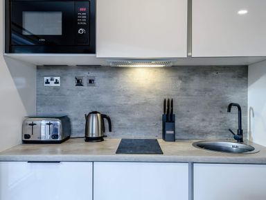 A kitchen with a microwave toaster and kettle at Somersby (Pet) Louth