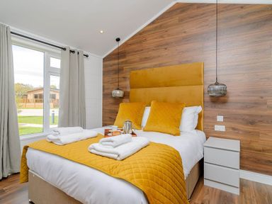 A bedroom with a bed and window at The Woodnewton in Wansford