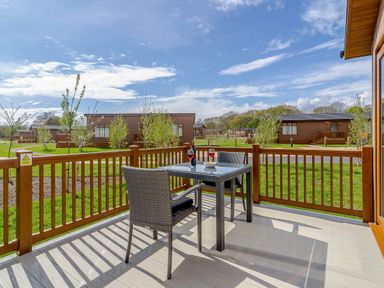 An outdoor seating area with a table and chairs at The Woodnewton in Wansford