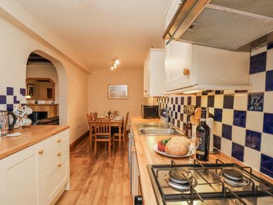 A kitchen with a dining table and chairs at 2 High Stakesby Cottages in Whitby