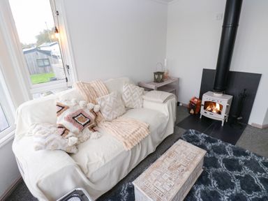 A living room with a couch and fireplace at John's Folly