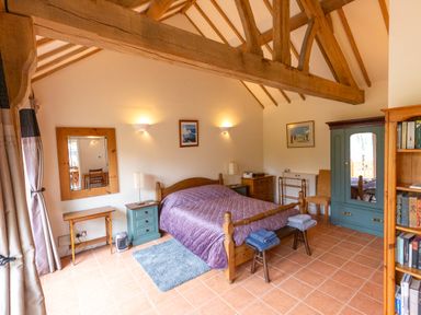 A bedroom with a bed and wardrobe at Nature's Lodge in Cookley