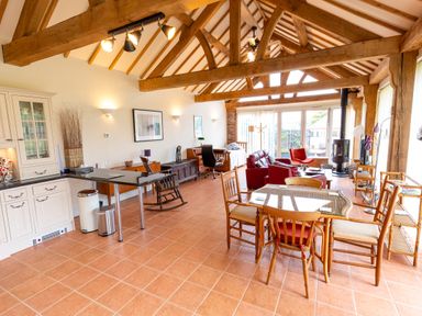 A living room with a table and chairs at Nature's Lodge in Cookley