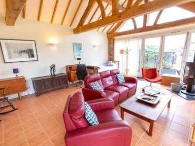 A living room with a sofa and coffee table at Nature's Lodge in Cookley