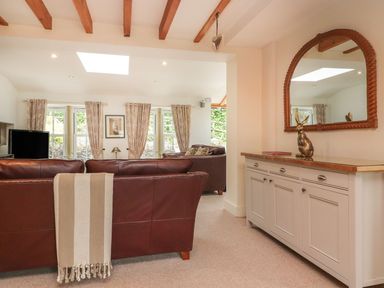 A living room with a sofa and TV at Bobbin Mill Cottage Ulverston