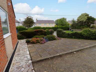 An outdoor area with paving stones and flowers at Gelli - Morfa Nefyn in Morfa Nefyn