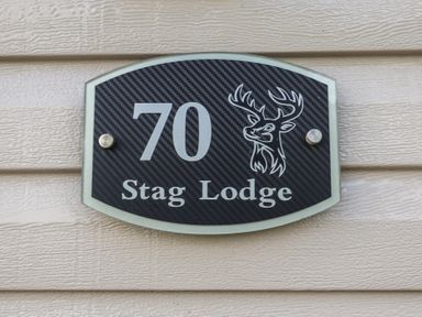 A plaque with the number 70 and Stag Lodge at Stag Lodge, Caravan 70 Great Yarmouth